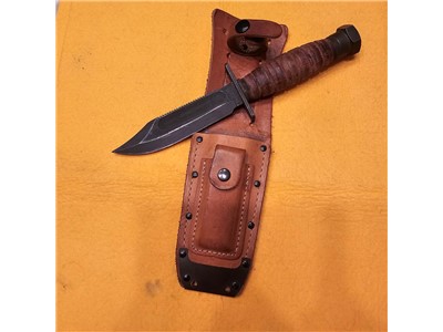 1986 Ontario Survival Knife with sheath and stone.