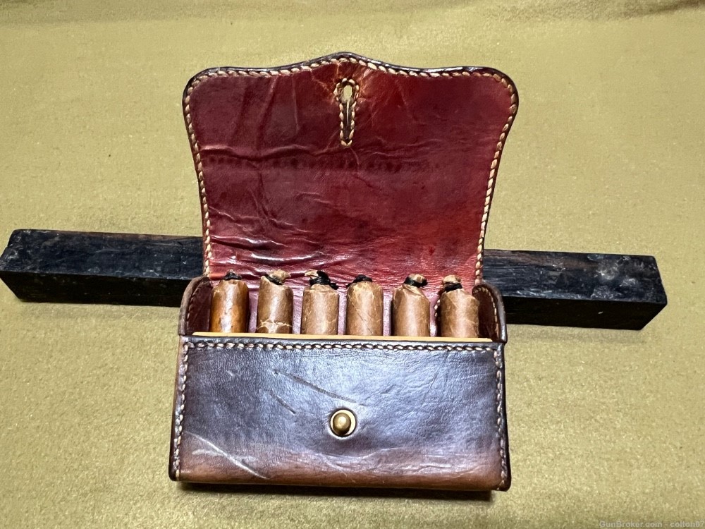 Possibly 45-70 paper Blackpowder cartridges in vintage leather pouch-img-0