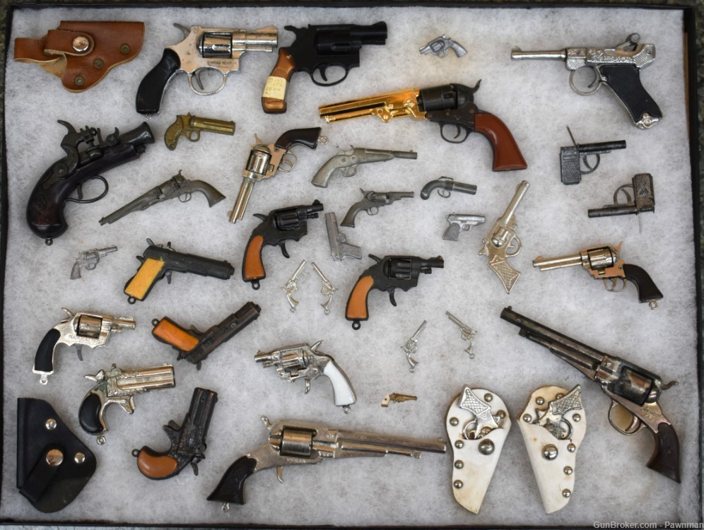 Vintage display of 33 miniature handguns + four miniature holsters-img-0