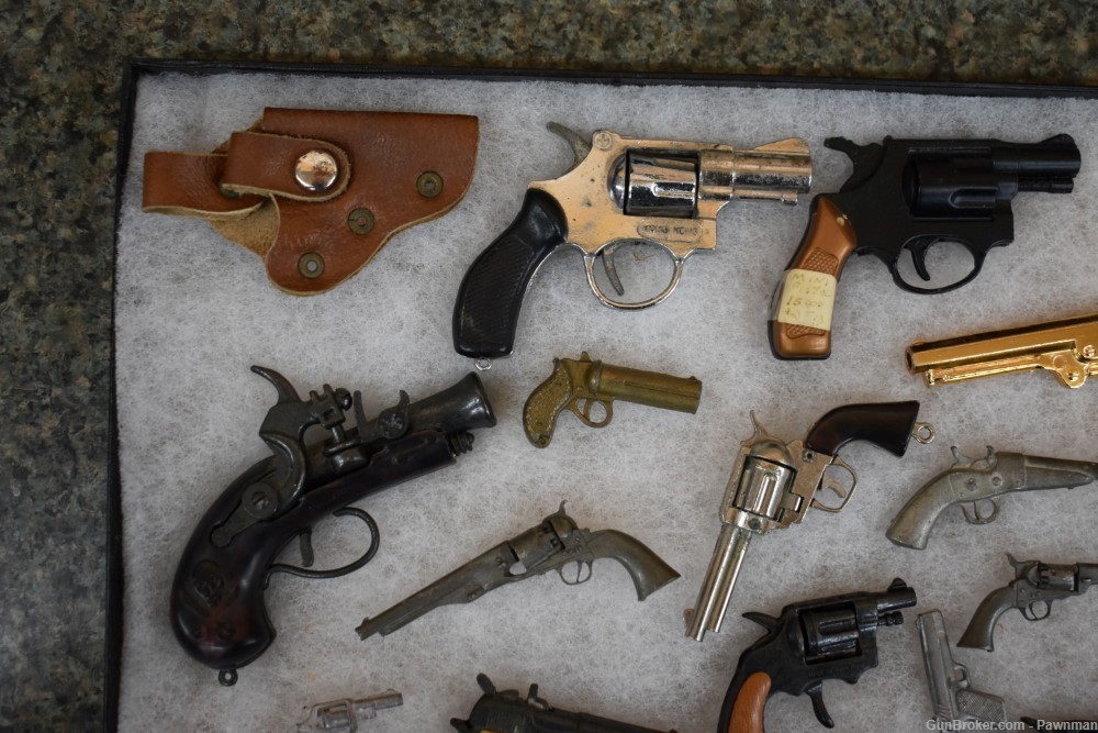 Vintage display of 33 miniature handguns + four miniature holsters-img-1