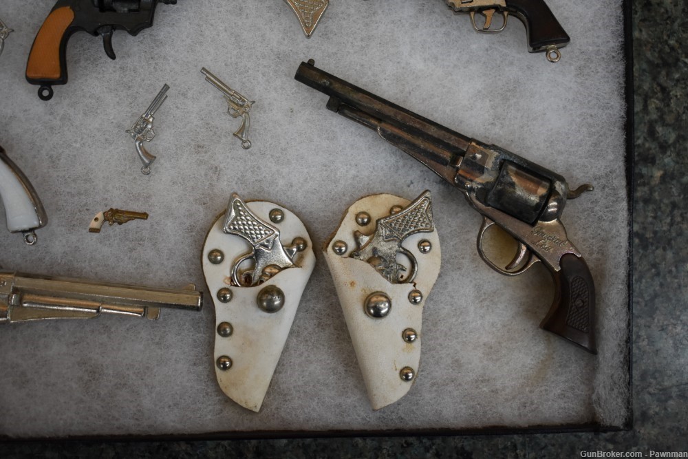 Vintage display of 33 miniature handguns + four miniature holsters-img-9