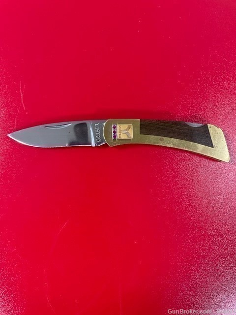 A Gerber 97223 folding lockback, wood with brass handle.  Marked "Veriflo"-img-0