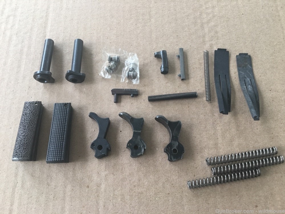 Misc 1911 pistol parts , new and used , hammer , springs etc.-img-0