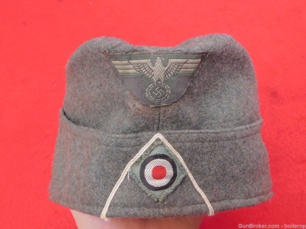 Wonderful German WW2 over seas army cap olive green dated tunic helmet -img-0