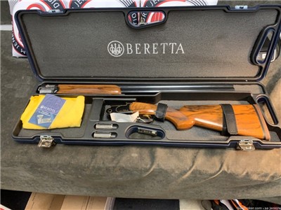 Beretta Gold & Black Over Under 12 Gauge shotgun.