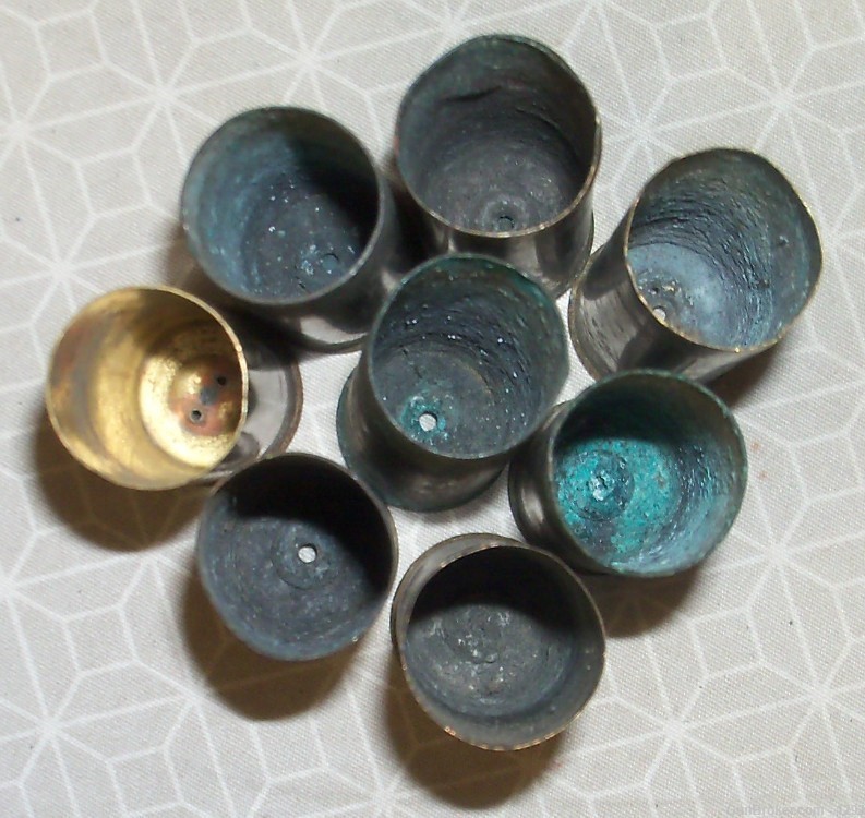 8 Various headstamped and conditions of 16 gauge brass shotgun shells.-img-1