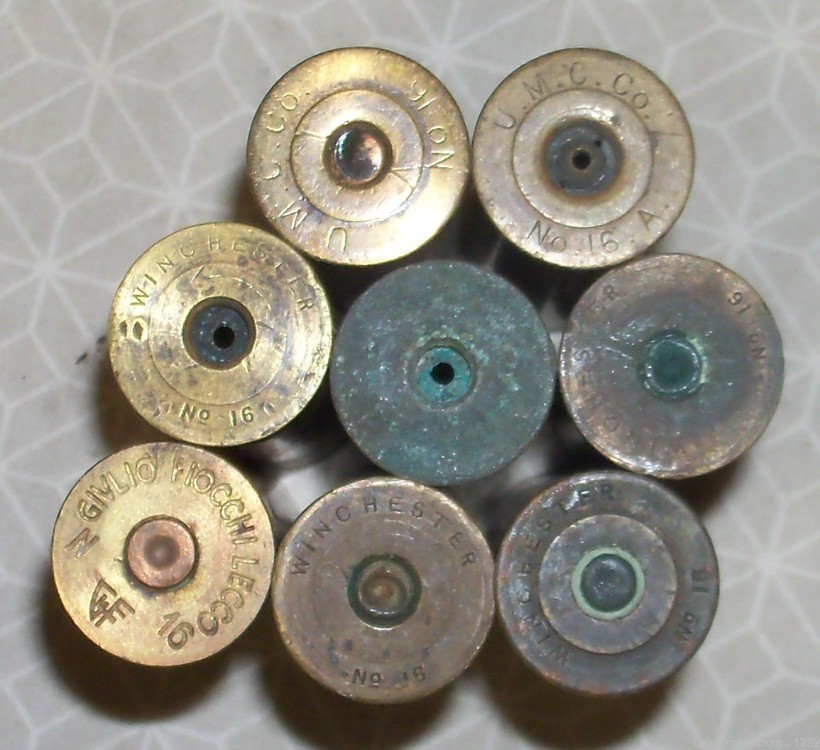 8 Various headstamped and conditions of 16 gauge brass shotgun shells.-img-0