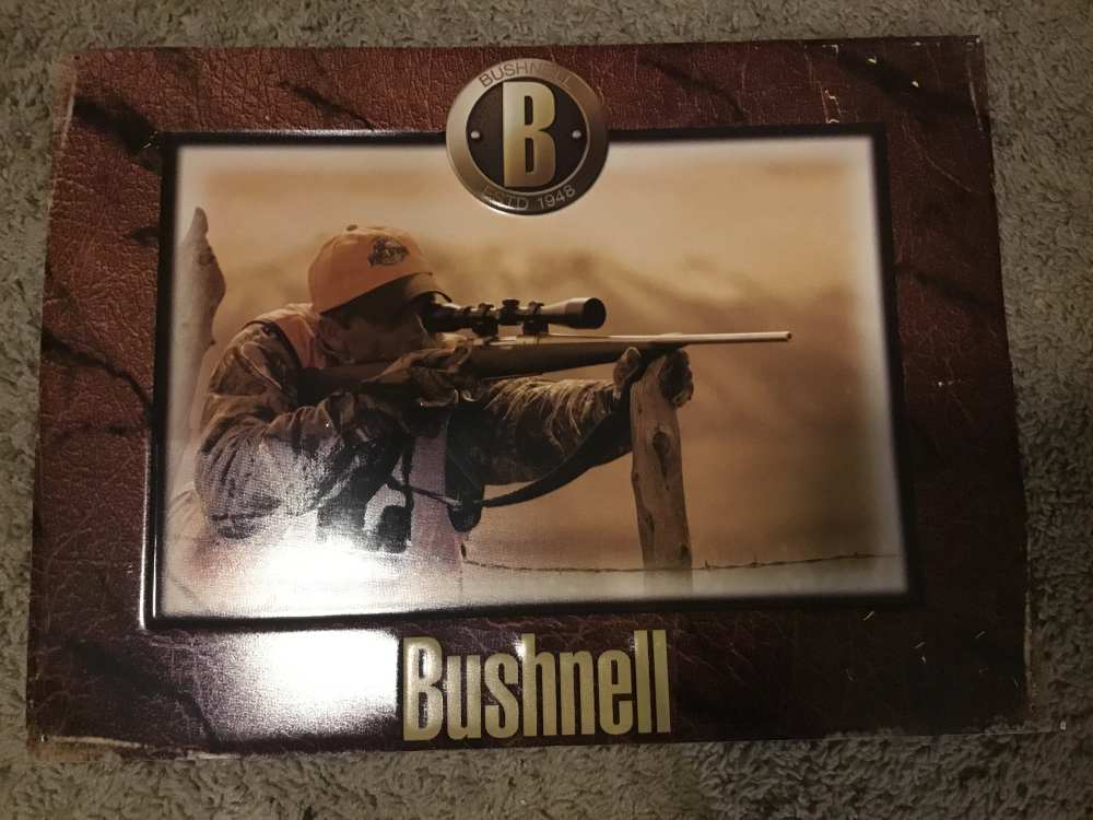 Bushnell Dealer sign showing hunter with his rifle-img-0