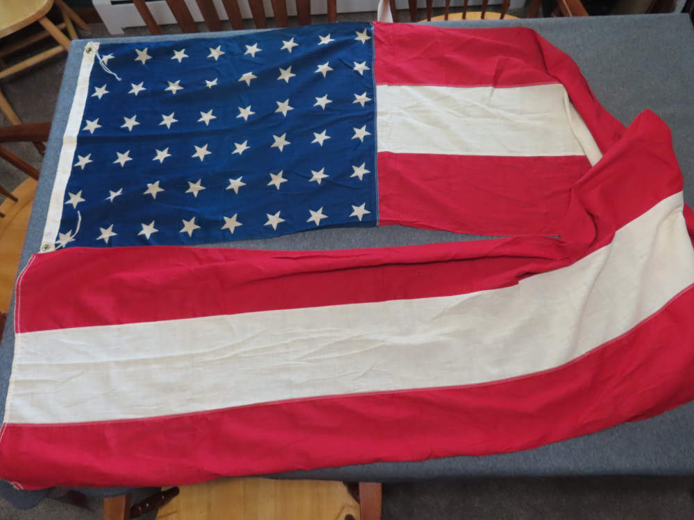 WWII 48 STAR FLAG BANNER THAT MEASURES 2' BY 10' WITH UNKNOWN MARKING-img-0