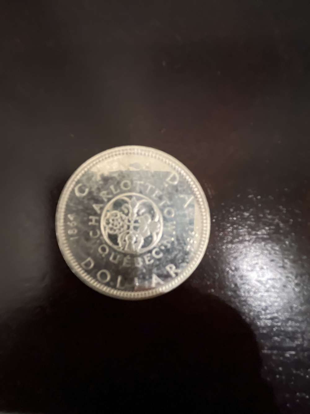 1864-1964 Canadian silver dollar -img-0